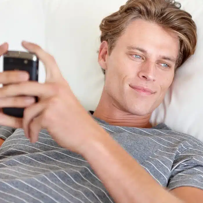 American man browsing international dating platforms on his phone