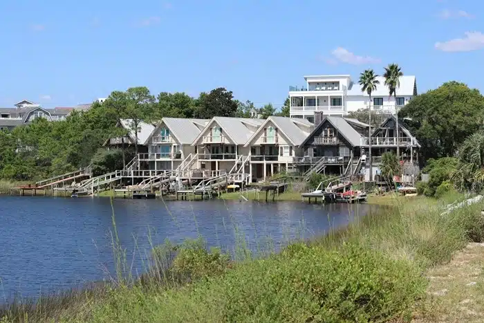 Florida vacation rentals with boat slip docks along a calm waterway surrounded by trees and blue skies