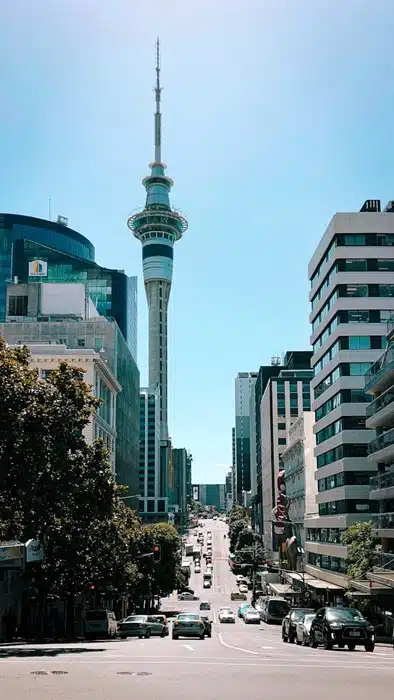 Auckland city street view with the Sky Tower rising above the buildings on a clear sunny day