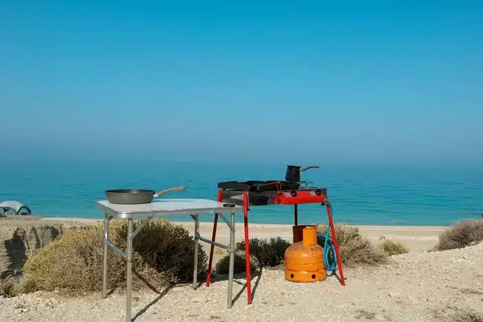 portable gas stove and frying pan set up outdoors near the australian coast