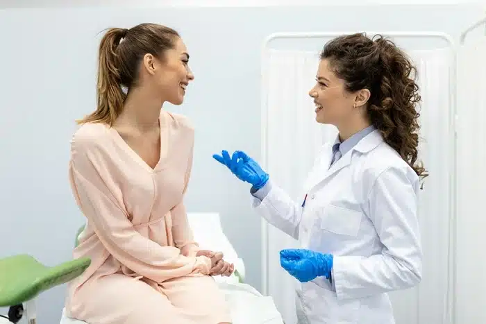 woman consulting with a skin care professional about her skin concerns in a clinical setting