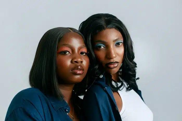 Two styles of bob wigs for black women — a straight sleek bob and a wavy voluminous bob