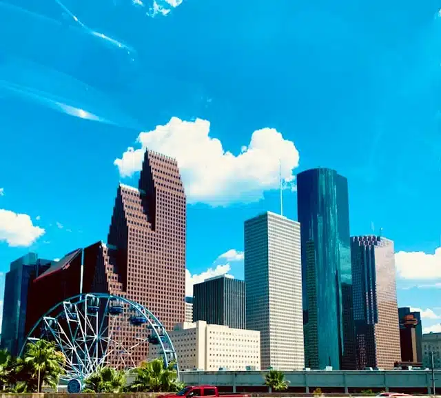 downtown Houston Texas cityscape featuring skyscrapers and a Ferris wheel on a sunny day