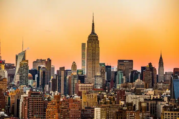 Manhattan skyline at sunset with the Empire State Building rising above the New York City cityscape