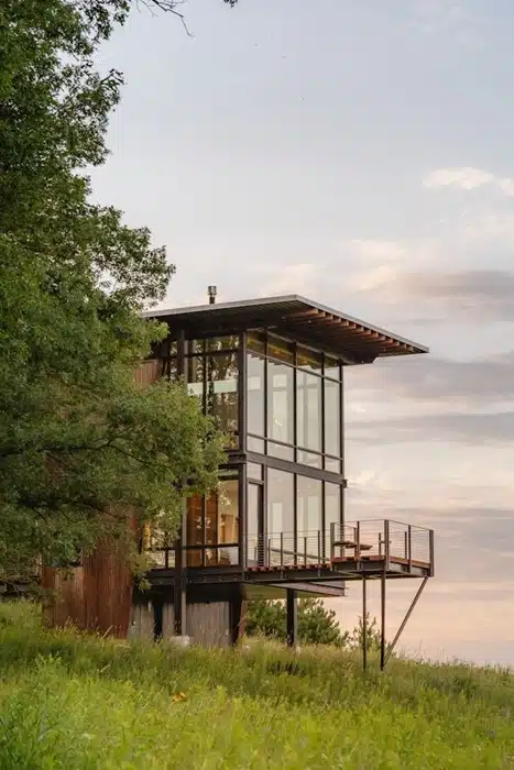 modern vacation rental property surrounded by trees and open landscape