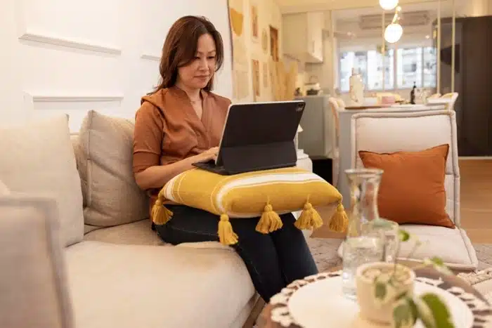 woman managing timeshare rental bookings from home on a laptop