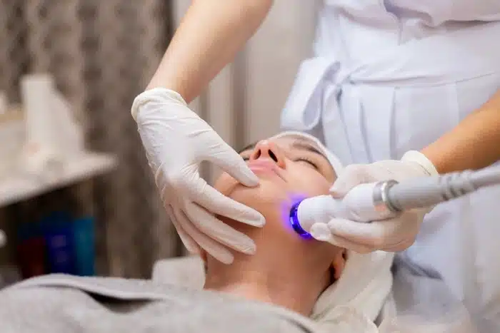 professional LED blue light facial treatment being administered by a licensed skin therapist
