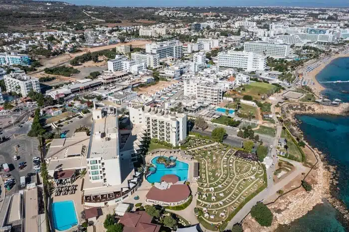 Aerial view of Protaras coastline with hotels and clear turquoise water
