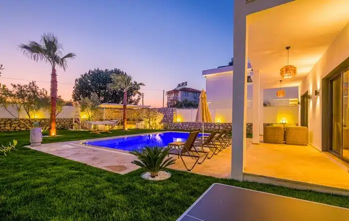 luxury timeshare resort with outdoor pool and garden at sunset