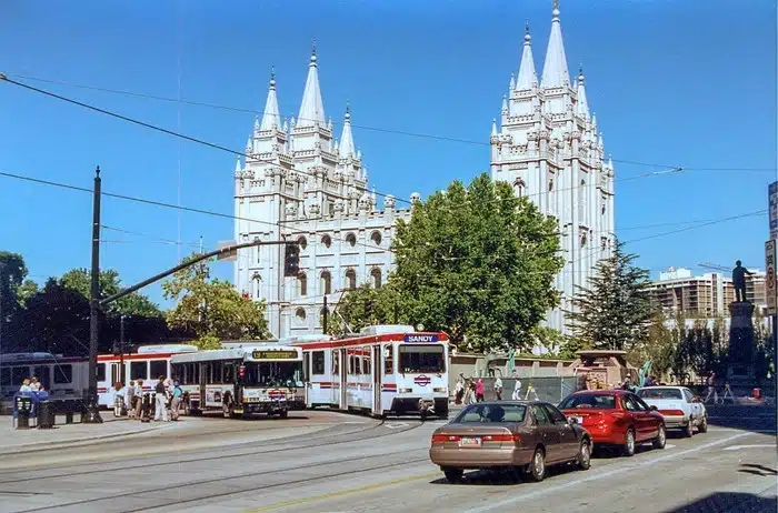 TRAX light rail train passing Salt Lake City Temple Square on a clear day