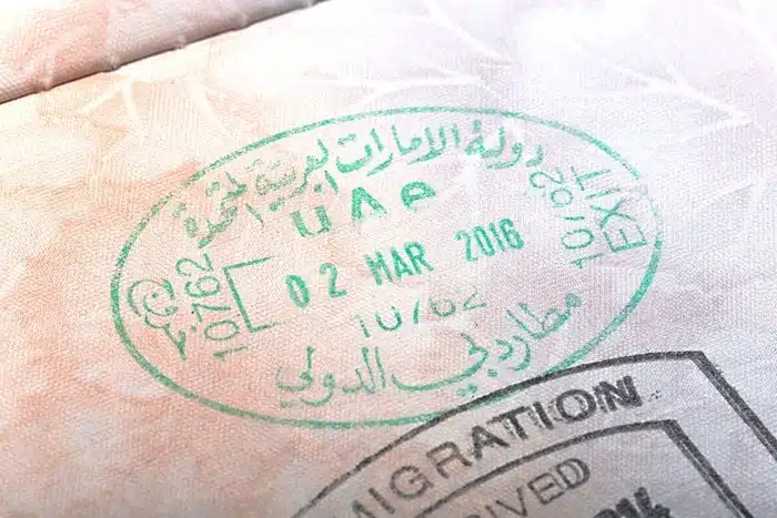 Close-up of a UAE entry stamp on a passport page with an immigration arrival seal