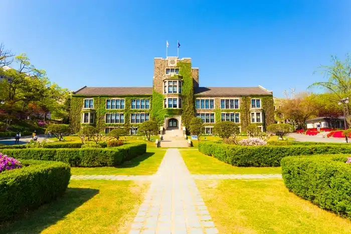 Yonsei University main building covered in ivy surrounded by manicured gardens in Seoul, South Korea