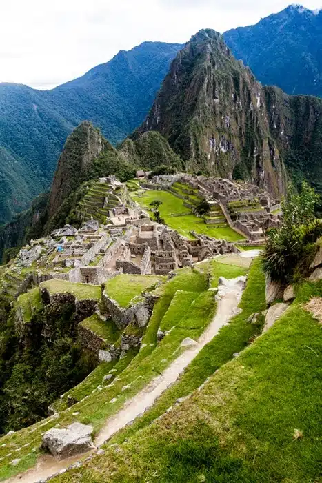 Machu Picchu ruins seen from above, with Huayna Picchu rising in the background