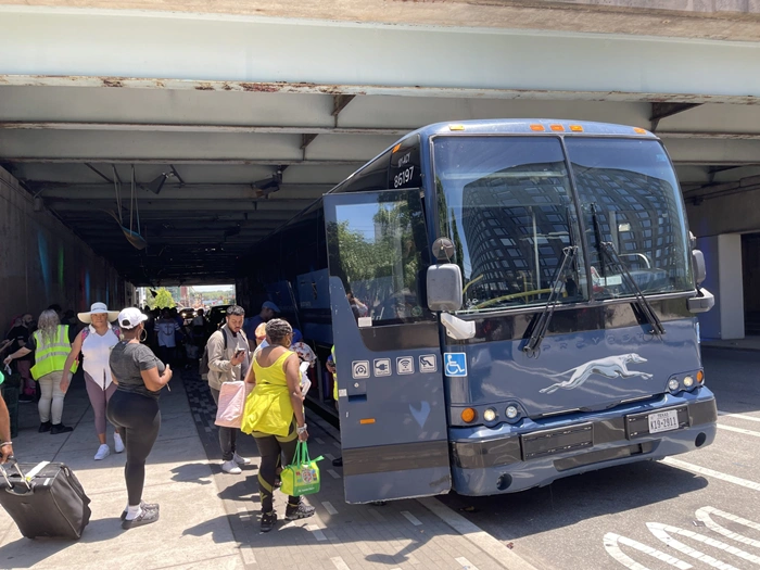 Passengers boarding a Greyhound bus at a Miami stop — an affordable way to travel to Miami on a budget