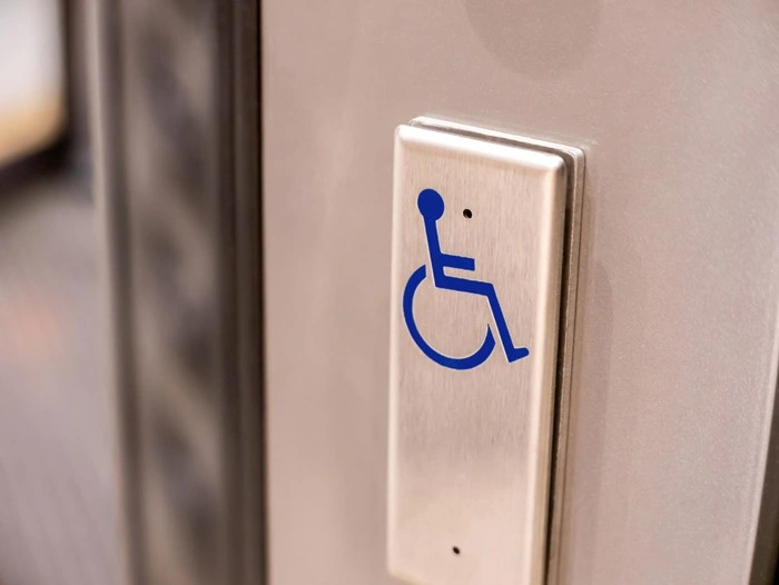 Wheelchair accessibility button on a hotel elevator door