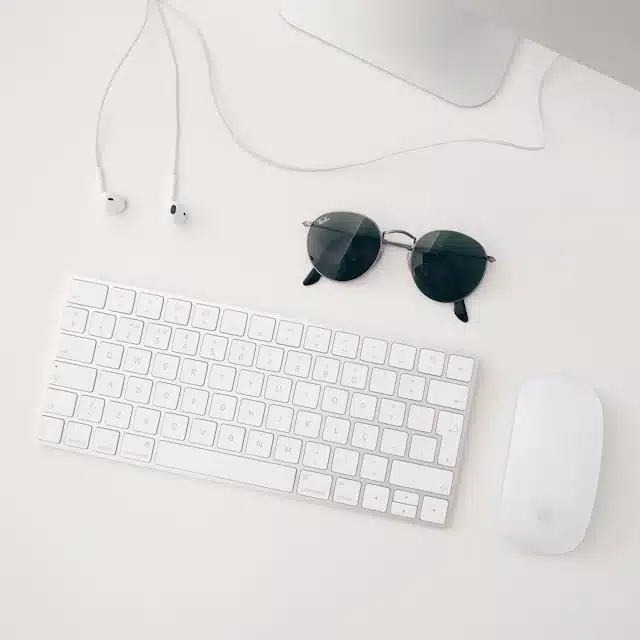 Shopping for prescription sunglasses online next to a keyboard and mouse on a desk