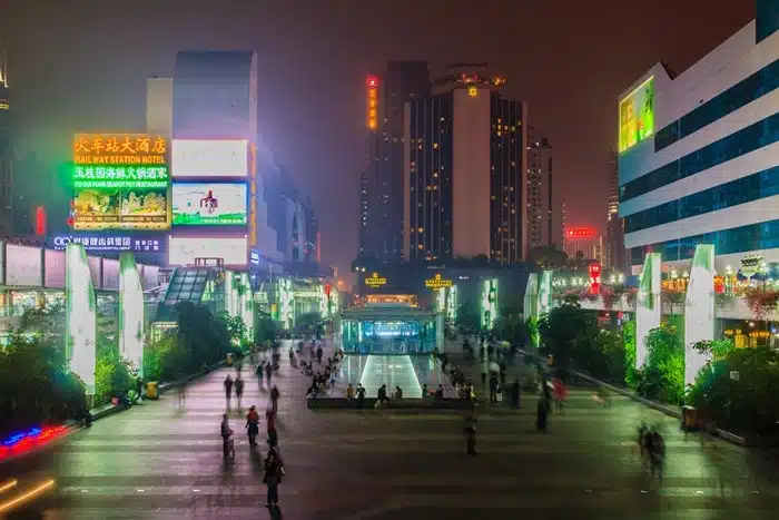 Luohu district in Shenzhen lit up at night with hotel signage and pedestrian plaza