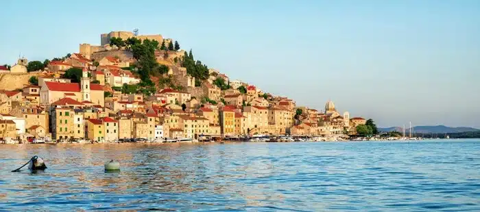 view of Šibenik's old town and hilltop fortress along the Dalmatian Coast seen from the water