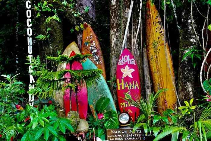 Things to do in Maui for first timers including stops at colorful painted surfboards and local shops along the Road to Hana