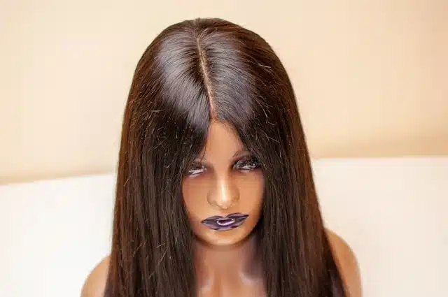Mannequin head displaying a smooth, straight wig with a defined parting