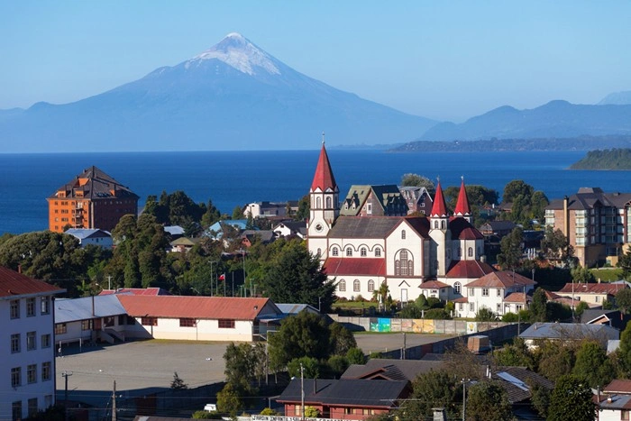Puerto Varas cityscape in Chile's Lake District, with Osorno Volcano rising above the lake and Patagonia in the distance