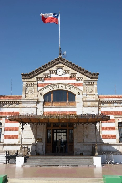 Historic customs building (Aduana) in Chile with the Chilean flag flying above the entrance