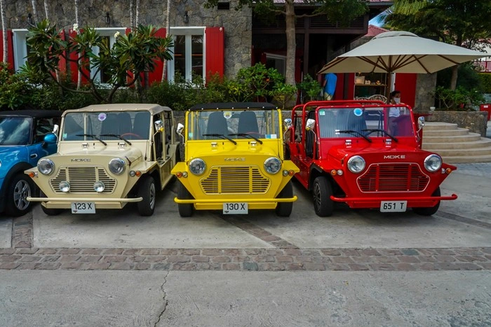 Colorful fleet of Mini Moke rental cars parked in St Barts, a popular choice for exploring the island