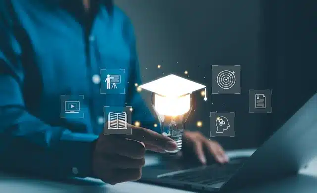 Person using laptop with graduation cap lightbulb and online learning icons