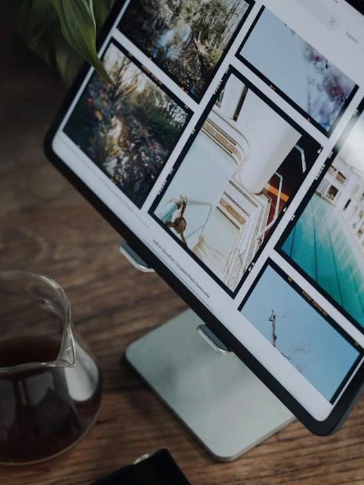 Tablet displaying a shared online photo gallery grid, ideal for viewing event photos together