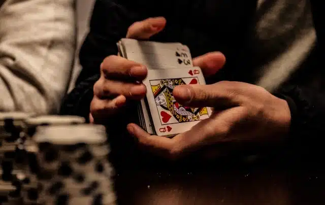 Hands shuffling a deck of cards to play a game during a flight