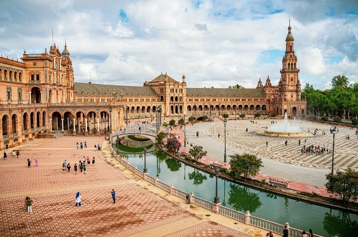 Plaza de España in Sevilla, Andalusia, with visitors enjoying a warm summer day