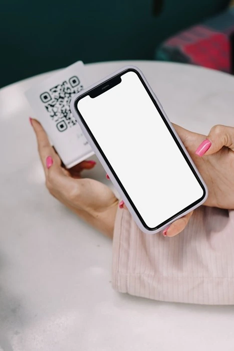 Guest scanning a QR code with a smartphone to join an event's online photo gallery