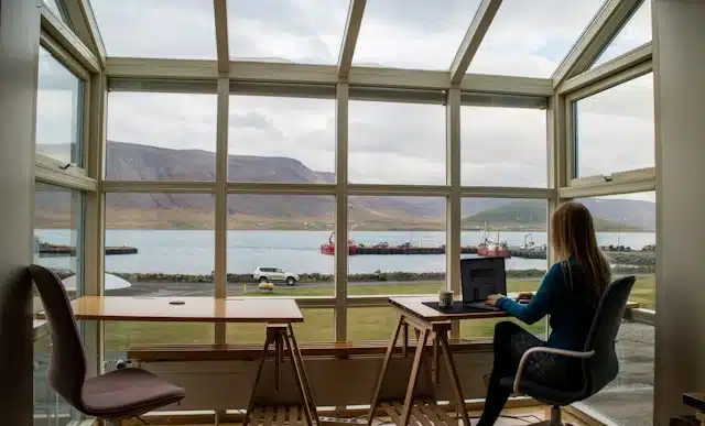 Remote student working online with mountain and harbor view