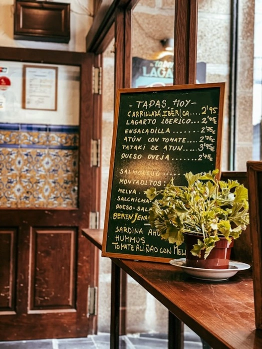 Chalkboard menu lists daily tapas specials at a traditional Spanish bar
