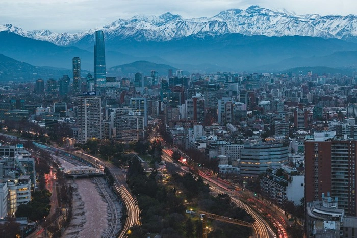 Aerial view of Santiago's skyline at dusk with the snow-capped Andes mountains in the background