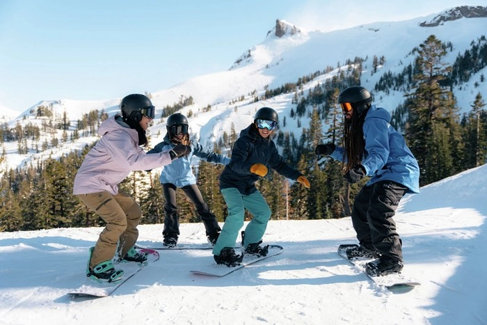 Snowboard instructor high-fiving students during a lesson at Kirkwood Resort