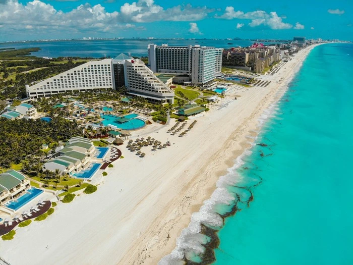 Aerial view of Cancun's hotel zone with beachfront resorts along the Mexican Caribbean coastline