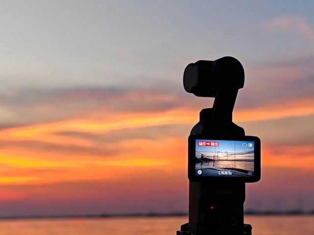 Gimbal camera silhouette filming a golden sunset