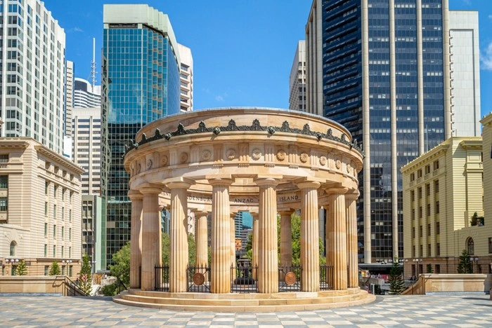 Anzac Square memorial shrine surrounded by Brisbane's skyscrapers on a sunny day