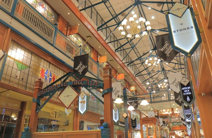 Stained glass windows and vintage chandeliers inside Brisbane Arcade's heritage shopping centre