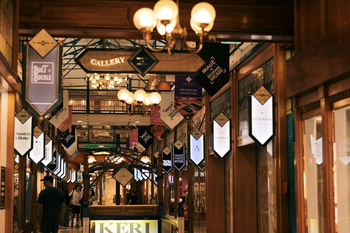 Elegant shopping arcade in Brisbane with vintage chandeliers and boutique storefronts