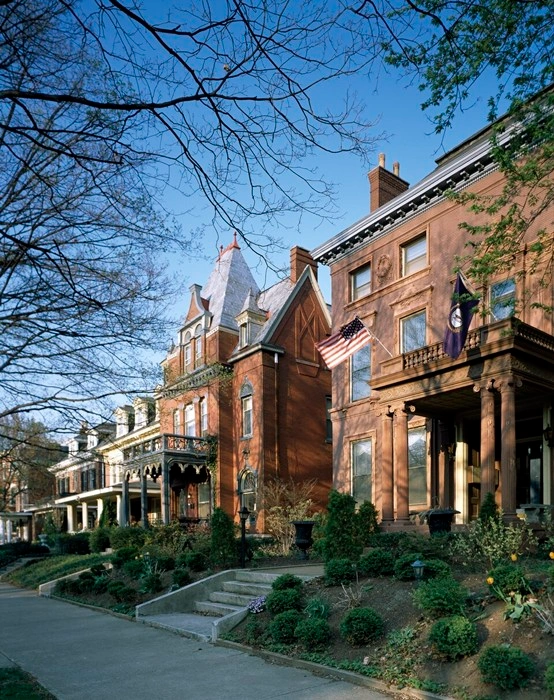Historic brick homes in a Louisville neighborhood, showcasing the housing style side of the Louisville or New Albany debate