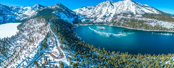 Aerial view of Lake Tahoe surrounded by snow-capped mountains near Kirkwood, California