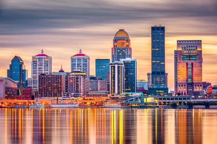 Louisville, Kentucky skyline at sunset reflecting on the Ohio River
