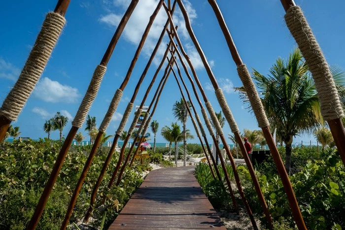 Wooden walkway with rope archways leading to the beach in Playa Mujeres, Cancun, Mexico