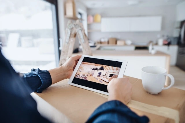 Homeowner reviewing kitchen design tips on a tablet during a remodeling consultation