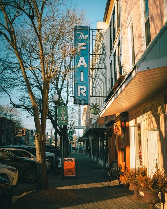 Vintage 'The Fair' sign along a downtown New Albany, Indiana storefront street