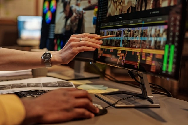 Editor reviewing footage timeline on dual monitor setup