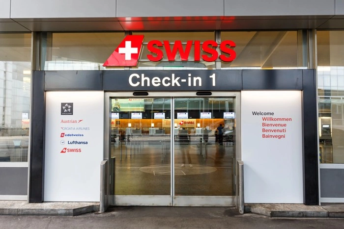 SWISS Airlines check-in entrance at Zurich Airport, where travelers begin their journey before arranging transfer or chauffeur pickup.
