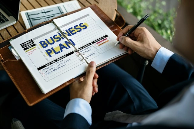 Businessman reviewing a business plan binder, adjusting strategy after a setback